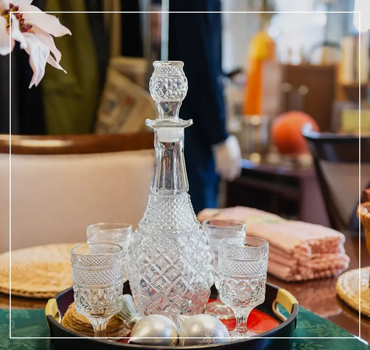 A glass decanter and glasses on a tray.