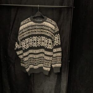 A sweater hanging on the wall in a room.