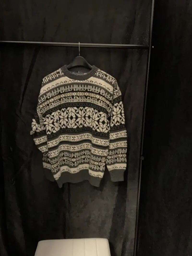 A sweater hanging on the wall in a room.