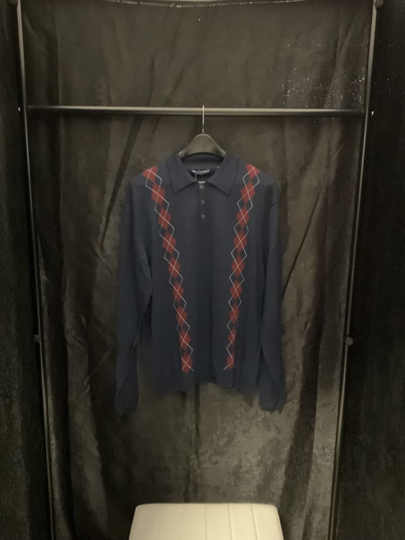 A black and red shirt hanging on a rack.