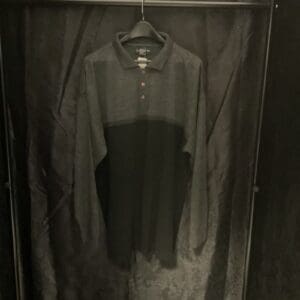 A black shirt hanging on the wall in a room.