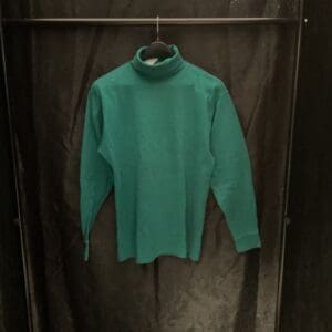 A green shirt hanging on a rack