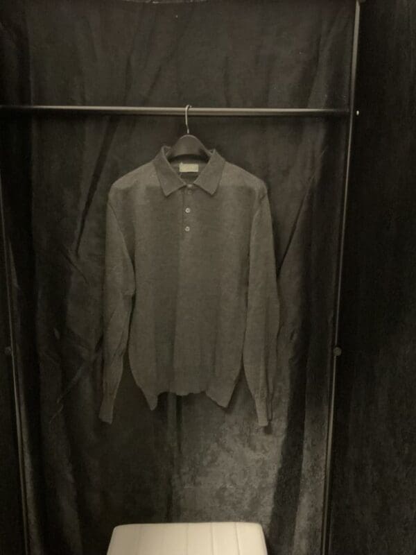 A shirt hanging on the wall in a closet.