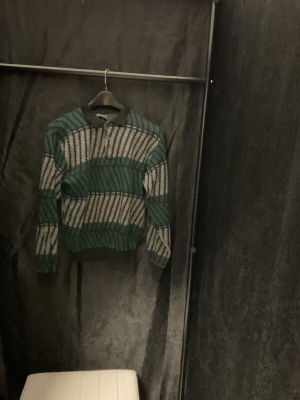 A sweater hanging on the wall in a room.