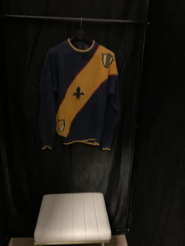 A sweater hanging on the wall in a room.