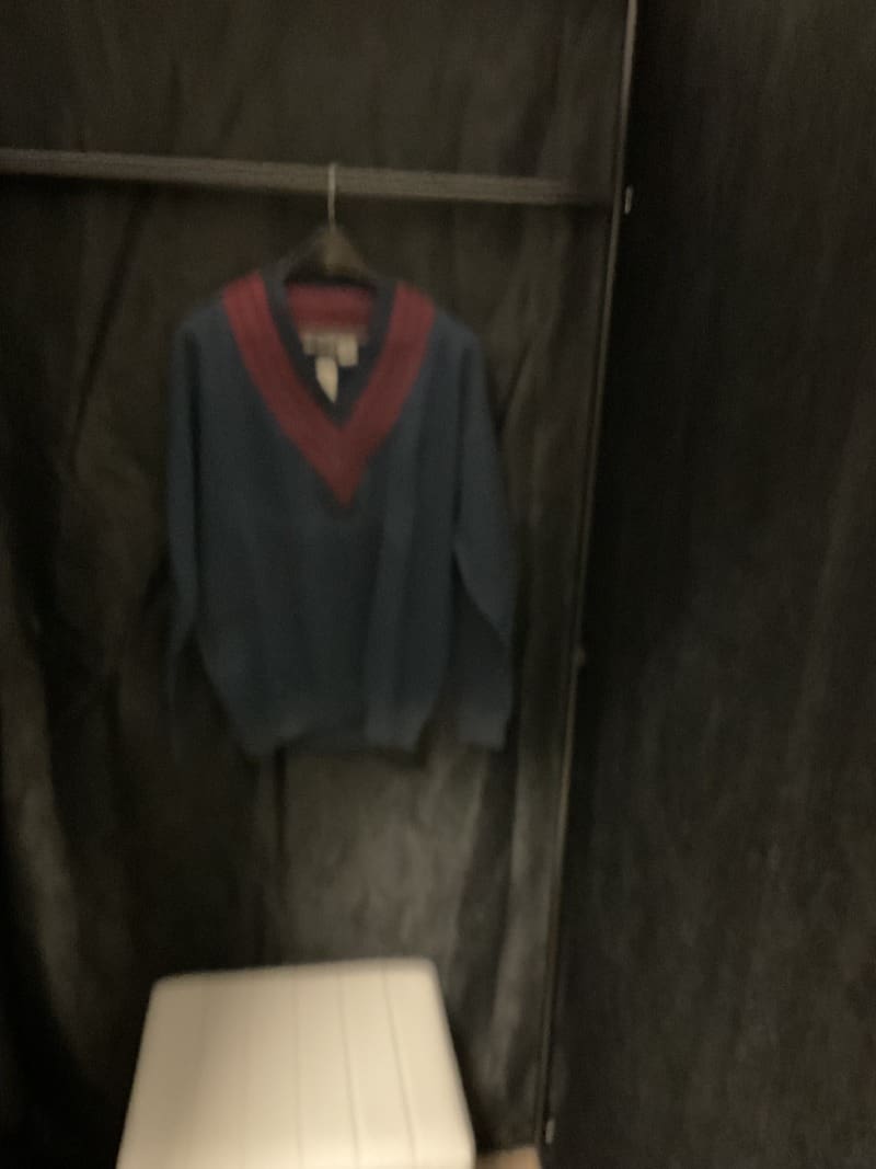 A sweater hanging on the wall in a room.