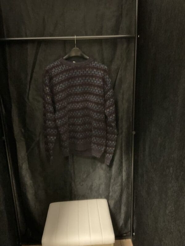 A sweater hanging on the wall in a room.