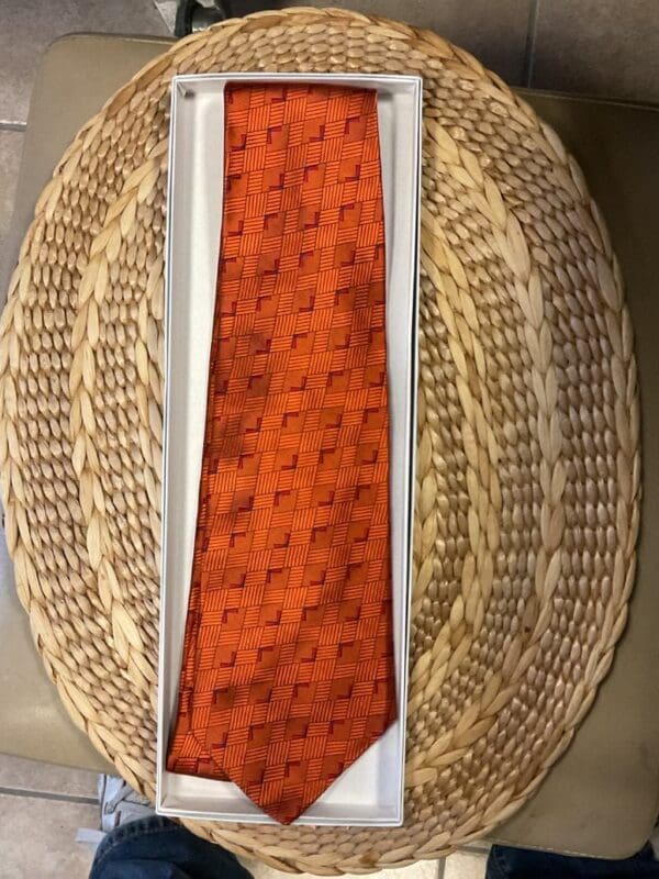 A basket with two ties on top of it.