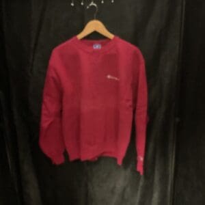 A red sweater hanging on the wall