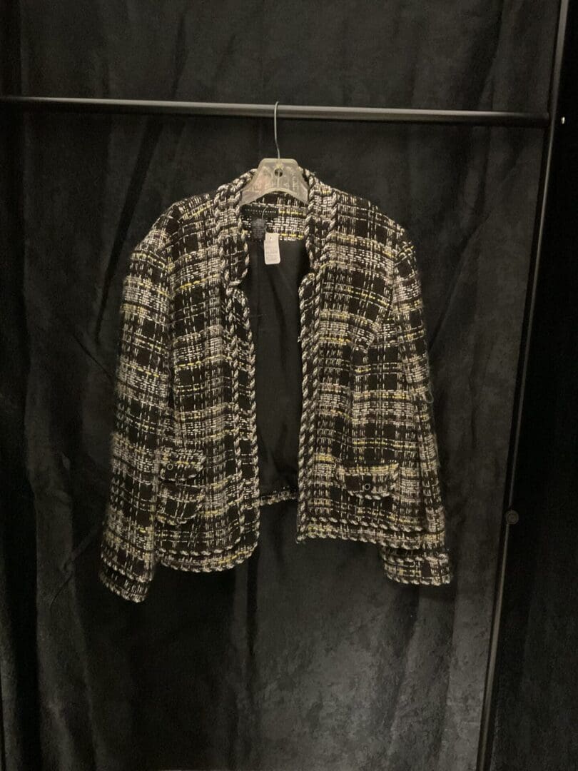 A jacket hanging on a clothes rack.