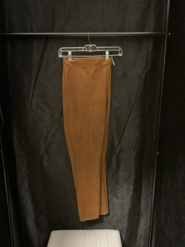 A pair of pants hanging on a rack.