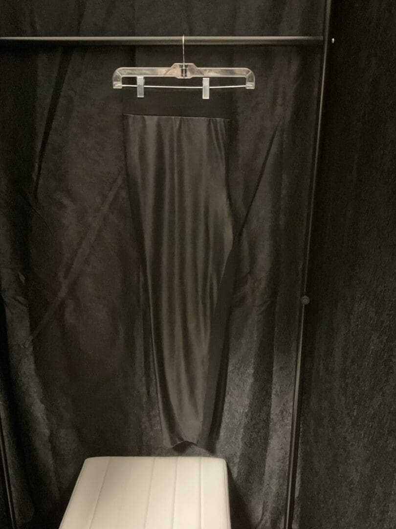 A shower curtain hanging over the toilet in a bathroom.