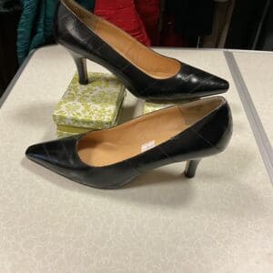 A pair of black shoes sitting on top of a table.