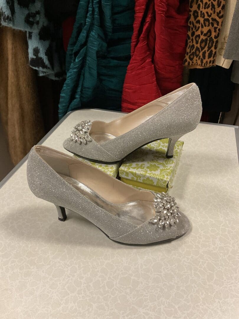 A pair of silver shoes sitting on top of a table.