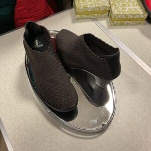 A pair of shoes sitting on top of a glass plate.