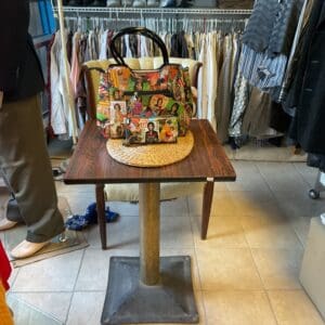 A table with a bag on it in a store.