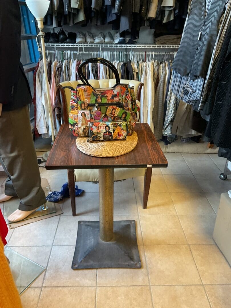 A table with a bag on it in a store.