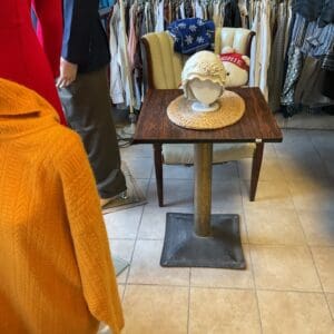 A table with a cup on it in the middle of a room.