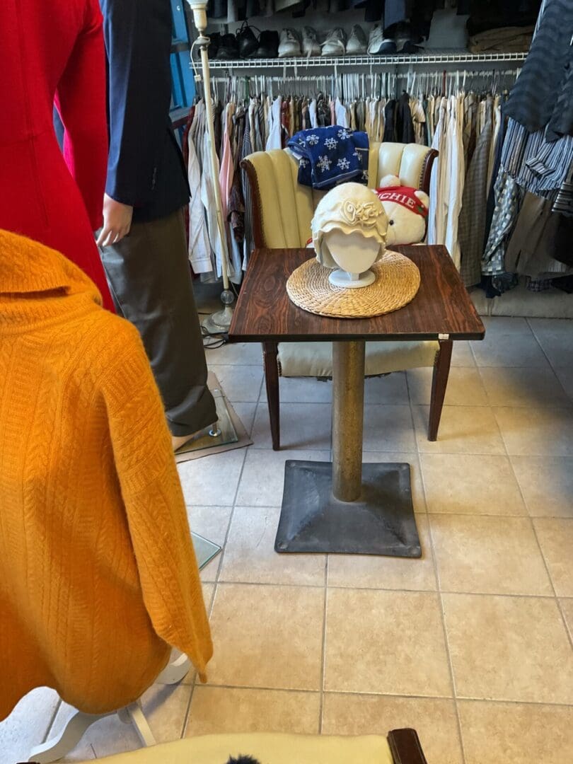 A table with a cup on it in the middle of a room.